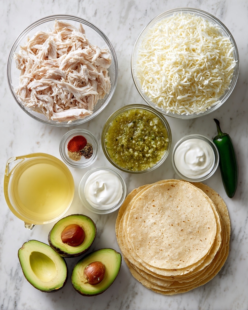 The image shows ingredients for a dish laid out neatly on a white marbled surface. There is a clear glass bowl filled with shredded light pink cooked chicken placed near the bottom left. Above it, there is a small metal cup with white rice and next to that, a large clear glass measuring cup filled with yellow liquid, likely broth or oil. In the center, a small clear bowl holds green salsa, and beside it, another small glass bowl contains white sour cream. Next to the sour cream, a tiny round dish has salt, red, and brown spices. On the top right, a big clear bowl is heaped with shredded white cheese. To the right of the cheese bowl, there are corn tortillas stacked together, showing a soft yellow tone and layered one over the other. Near the top center, there are two halves of a bright green avocado, with another whole avocado placed beside them. Above the avocado halves, a single dark green jalapeño pepper lies horizontally. The photo taken with an iphone --ar 4:5 --v 7