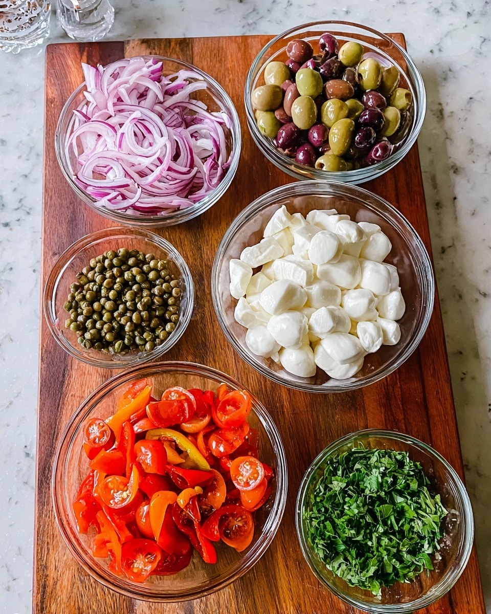 There are six clear glass bowls arranged on a brown wooden board with a white marbled background. The top left bowl holds thinly sliced red onions with a mix of white and purple colors, while the bowl next to it has sliced green and purple olives showing smooth and shiny textures. To the right, there is a larger bowl filled with white mozzarella cheese pieces, round and soft in appearance. Below, a medium bowl is full of halved cherry tomatoes that are red with green undertones, glossy and juicy looking. On the bottom left, a small bowl contains green capers, round and matte. Next to it is a medium bowl with bright red and orange roasted bell peppers, glistening as well. To the far right, chopped fresh green herbs are spread directly on the wooden surface. photo taken with an iphone --ar 4:5 --v 7