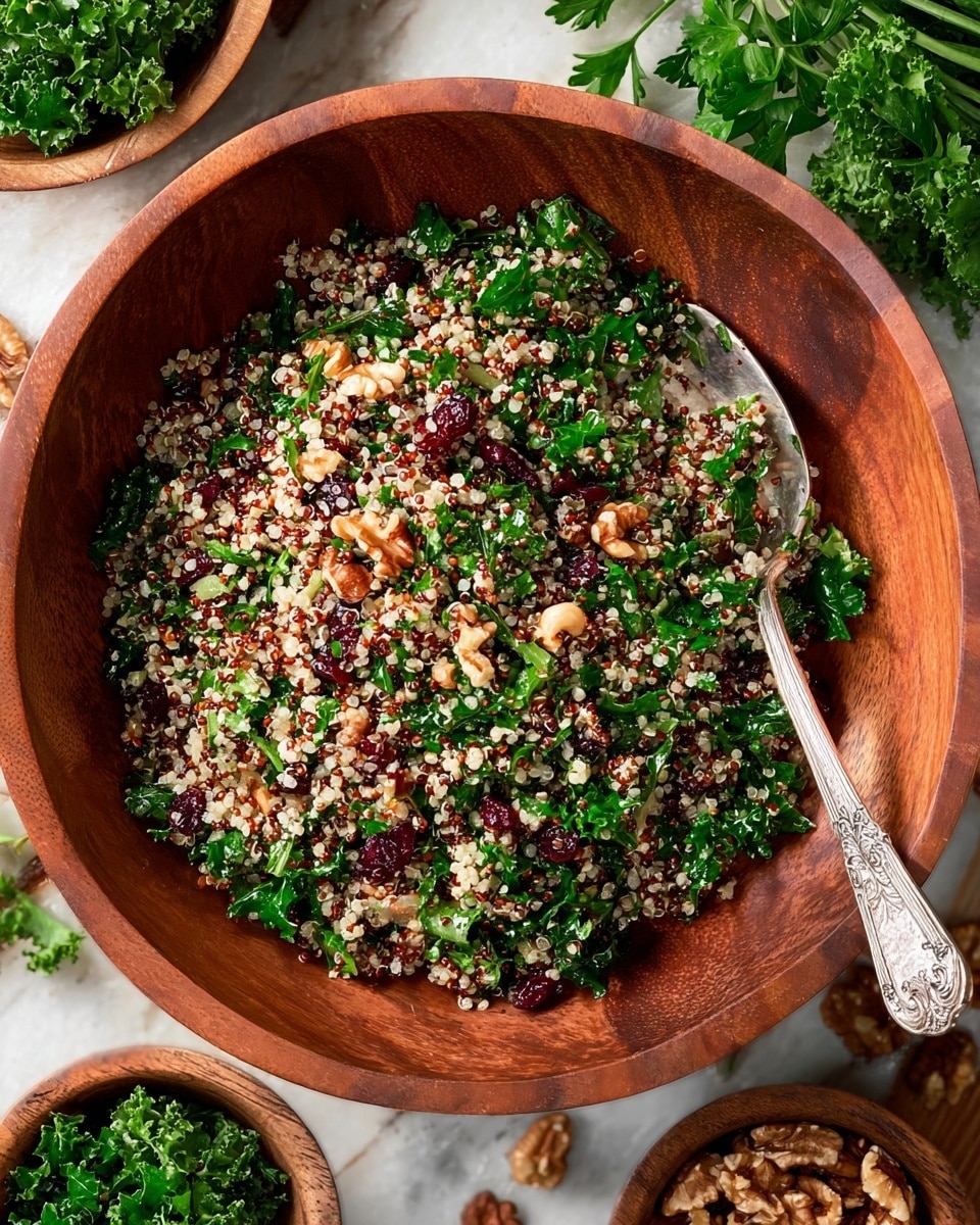 A wooden bowl filled with a colorful quinoa salad, showing three main layers mixed together: light beige and red quinoa grains, bright green chopped kale leaves, and dark red dried cranberries scattered through the salad. Small pieces of chopped nuts add texture, giving a crunchy look with brown and light tan colors. A vintage silver spoon with ornate detailing rests inside the bowl towards the top right. The background is a white marbled surface with a few sprigs of fresh parsley and small wooden bowls containing more kale and nuts around the main bowl. The overall scene looks fresh and natural with a mix of earthy and vibrant colors photo taken with an iphone --ar 4:5 --v 7