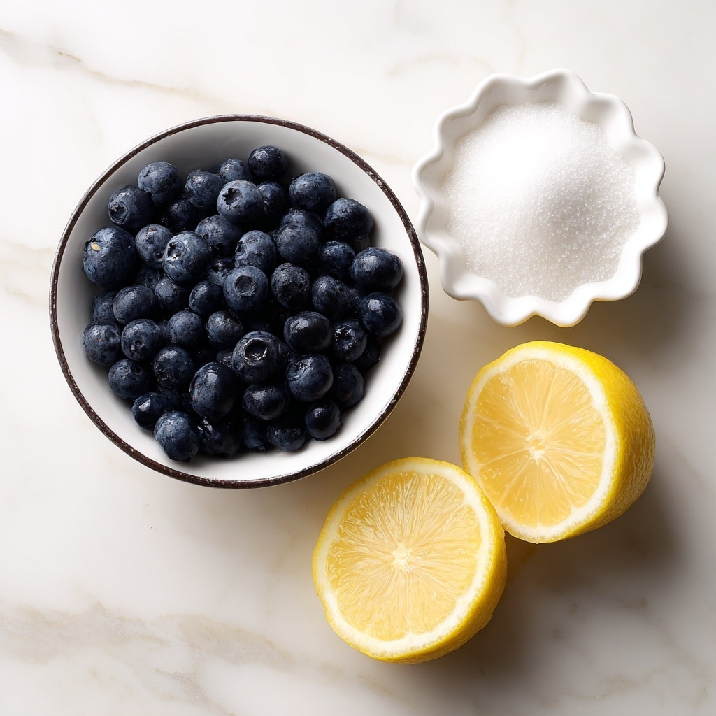 The image shows three main items on a white marbled surface: a small white bowl with a dark rim filled with fresh blueberries that are dark blue and round, a small white scalloped dish filled with white granulated sugar, and two halves of a lemon placed side by side showing their bright yellow juicy interior. The blueberries are at the bottom center, the sugar dish is placed to the upper left, and the lemon halves are at the upper right. The lighting highlights the textures clearly, making the blueberries look fresh and plump, the sugar fine and soft, and the lemon moist and fresh. Photo taken with an iphone --ar 4:5 --v 7