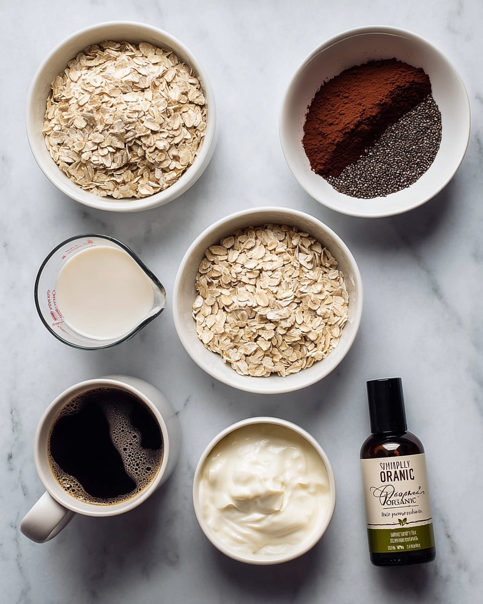 The image shows six containers arranged on a white marbled surface. In the top right, a white bowl is divided in half with dark brown cocoa powder on one side and small black chia seeds on the other. Below it, a clear measuring cup holds white plant milk. To its left, a white bowl is filled with light beige rolled oats. In the bottom right, a white bowl contains smooth white yogurt with soft peaks. Next to it, a small dark bottle labeled