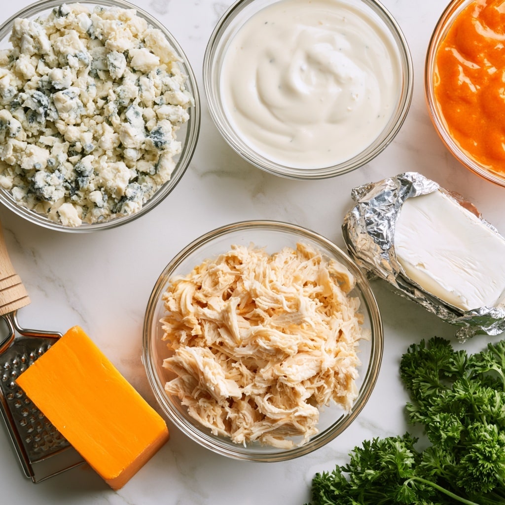The image shows several ingredients arranged on a white marbled surface, each in clear glass bowls or directly on the surface. At the top left is a bowl filled with crumbled blue cheese, showing a mix of white and light blue textures. To its right is a glass bowl with creamy white ranch dressing, smooth in texture, and next to it a bowl of bright orange hot wing sauce with a glossy finish. Below these, there is a block of cream cheese partly wrapped in silver foil, its soft white texture visible. Centered below, a clear glass bowl holds shredded chicken with light beige strands. To the left on the surface is a block of bright orange cheddar cheese placed on a small cheese grater with a wooden handle. On the bottom right, fresh green parsley with curly leaves lies next to the other ingredients. Photo taken with an iphone --ar 4:5 --v 7