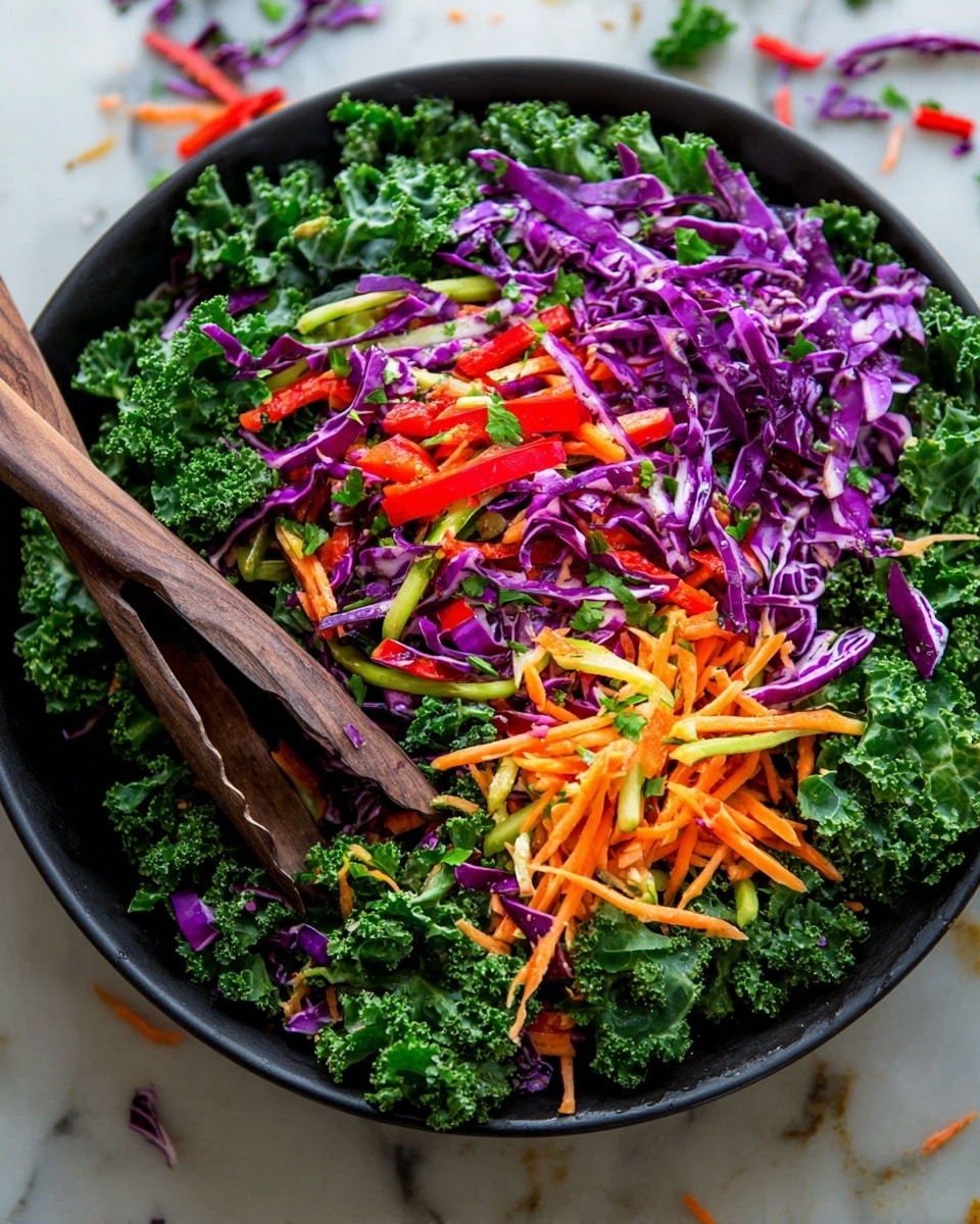 A black bowl is filled with a colorful salad showing three main layers: a base of deep green curly kale leaves with rough texture, a middle layer of thin, vibrant purple cabbage strips, and a top layer of finely shredded orange carrots, sliced light green celery, bright red bell pepper strips, and small green herbs mixed in. Two dark wooden salad tongs are partially inserted into the salad on the left side of the bowl, angled slightly downward. The bowl sits on a white marbled surface with scattered bits of vegetables around it. The photo taken with an iphone --ar 4:5 --v 7