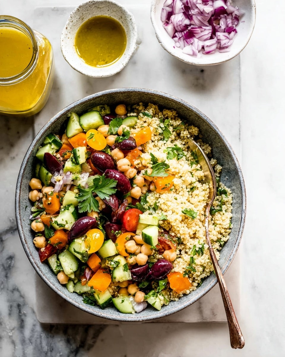 A bowl with three main layers: the bottom layer is light beige quinoa with a grainy texture filling most of the bowl; on top, there are mixed chopped vegetables with colors of green cucumber, yellow cherry tomatoes, orange tomato pieces, light tan chickpeas, and dark purple olives, all scattered evenly; fresh green parsley leaves are placed on top as garnish. A bronze spoon rests inside the bowl on the right side. The bowl is set on a white marbled surface with a small white dish holding chopped red onions and a glass jar of yellow dressing beside it. photo taken with an iphone --ar 4:5 --v 7