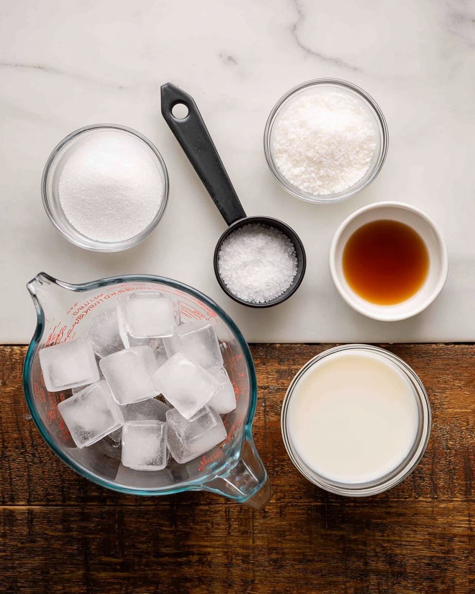 The image shows six clear glass containers placed on a white marbled surface. In the center, there is a glass measuring cup filled with clear ice cubes, some ice cubes are also outside the cup. To the left of the ice, a small round clear glass bowl holds white granulated sugar, and above it, a black measuring cup is filled with coarse white salt. On the right side, a rounded clear glass container is filled with white milk, and next to it, a small white bowl holds a small amount of dark amber liquid. The arrangement displays a simple, clean setup of ingredients on a rustic wooden table replaced by a white marbled texture. Photo taken with an iphone --ar 4:5 --v 7