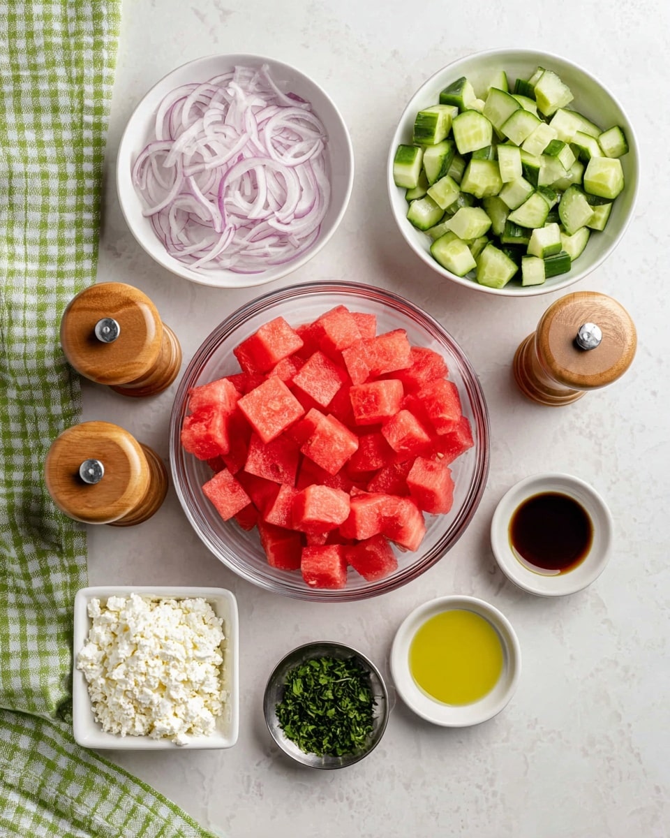 A clear bowl in the center holds bright red watermelon cubes with visible seeds, surrounded by smaller white bowls and containers. At the top, a white bowl filled with thin, light purple onion slices. To the right, a white bowl with fresh green cucumber cubes. Below the cucumber, there are three small cups showing light yellow, dark brown, and golden oil liquids, respectively. In the bottom left corner, a rectangular white container is filled with crumbly white cheese. Next to it, a small round silver bowl has fresh chopped green herbs. Two wooden salt and pepper shakers show natural wood tones. The whole arrangement sits neatly on a white marbled surface with a green and white checkered cloth partially visible at the bottom left. photo taken with an iphone --ar 4:5 --v 7