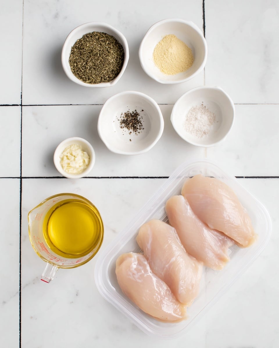 The image shows six white small bowls and a clear plastic tray on a white marbled surface with black tile lines. The clear tray at the bottom right holds three raw, pale pink chicken breasts. The white bowls are arranged around the tray: the top middle bowl contains dried green herbs, the middle left bowl has a light yellow powder, the middle right bowl contains white salt and black pepper, the bottom middle bowl has minced garlic, and the bottom left bowl is filled with golden yellow olive oil. Below the olive oil bowl is a clear measuring cup with light beige liquid. photo taken with an iphone --ar 4:5 --v 7