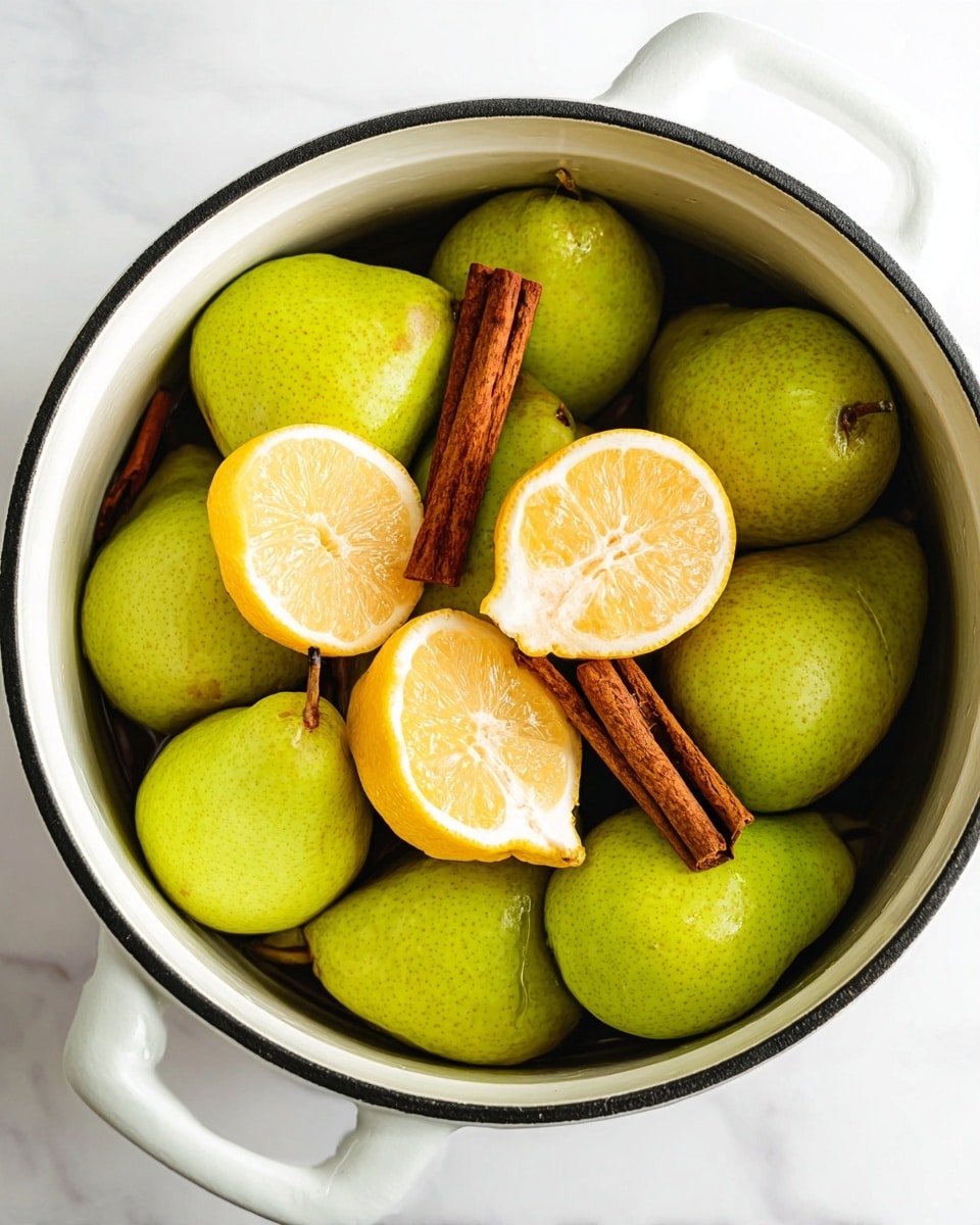 A white pot filled with whole green pears that have a smooth, slightly shiny texture, layered closely together to fill the pot. On top of the pears, there are two halved bright yellow lemons with visible juicy segments and white pith around the edges. Several brown cinnamon sticks with a rough, woody texture are placed among the pears and lemons. The pot is set on a white marbled surface, and the photo is taken with an iphone --ar 4:5 --v 7