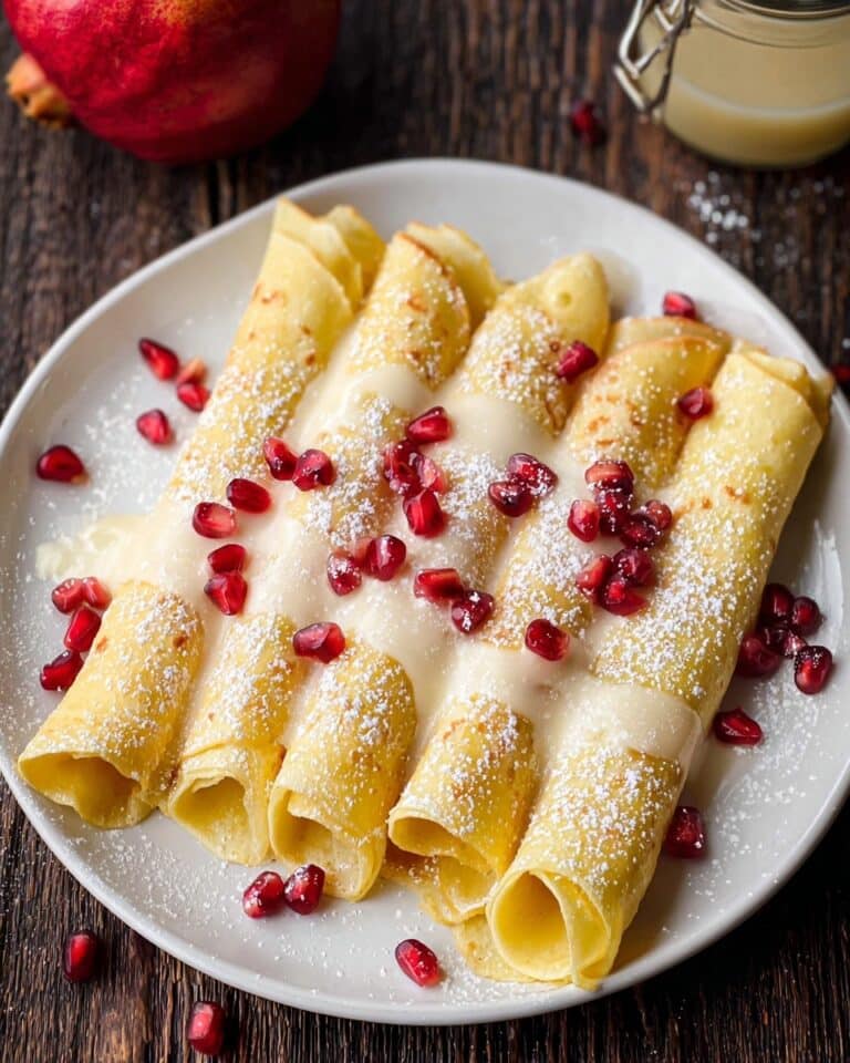 Eggnog Crepes with Eggnog Sauce, Pomegranate Arils, and Powdered Sugar Recipe