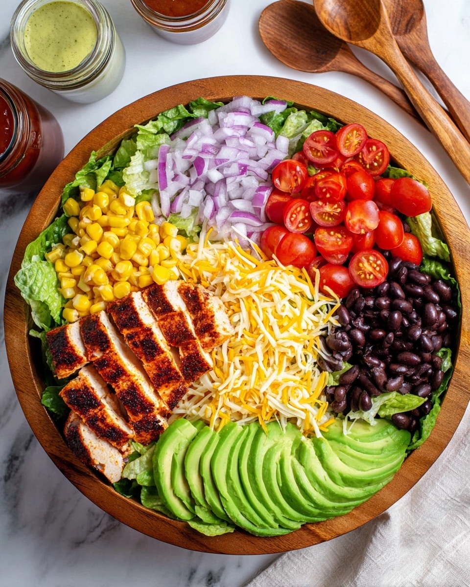 A large wooden bowl filled with fresh green romaine lettuce forms the base layer. On top, there are neat rows starting with thin purple onion slices on the left, followed by bright yellow corn kernels, a row of shiny black beans, and a group of halved red cherry tomatoes. In the center, there are sliced grilled chicken pieces with visible char marks and a reddish-brown spice coating. Above the chicken, a generous layer of shredded yellow and white cheese is spread. On the right side, thin slices of bright green avocado fan out. The bowl sits on a white marbled surface with wooden salad utensils visible in the background and small jars of sauces nearby. photo taken with an iphone --ar 4:5 --v 7