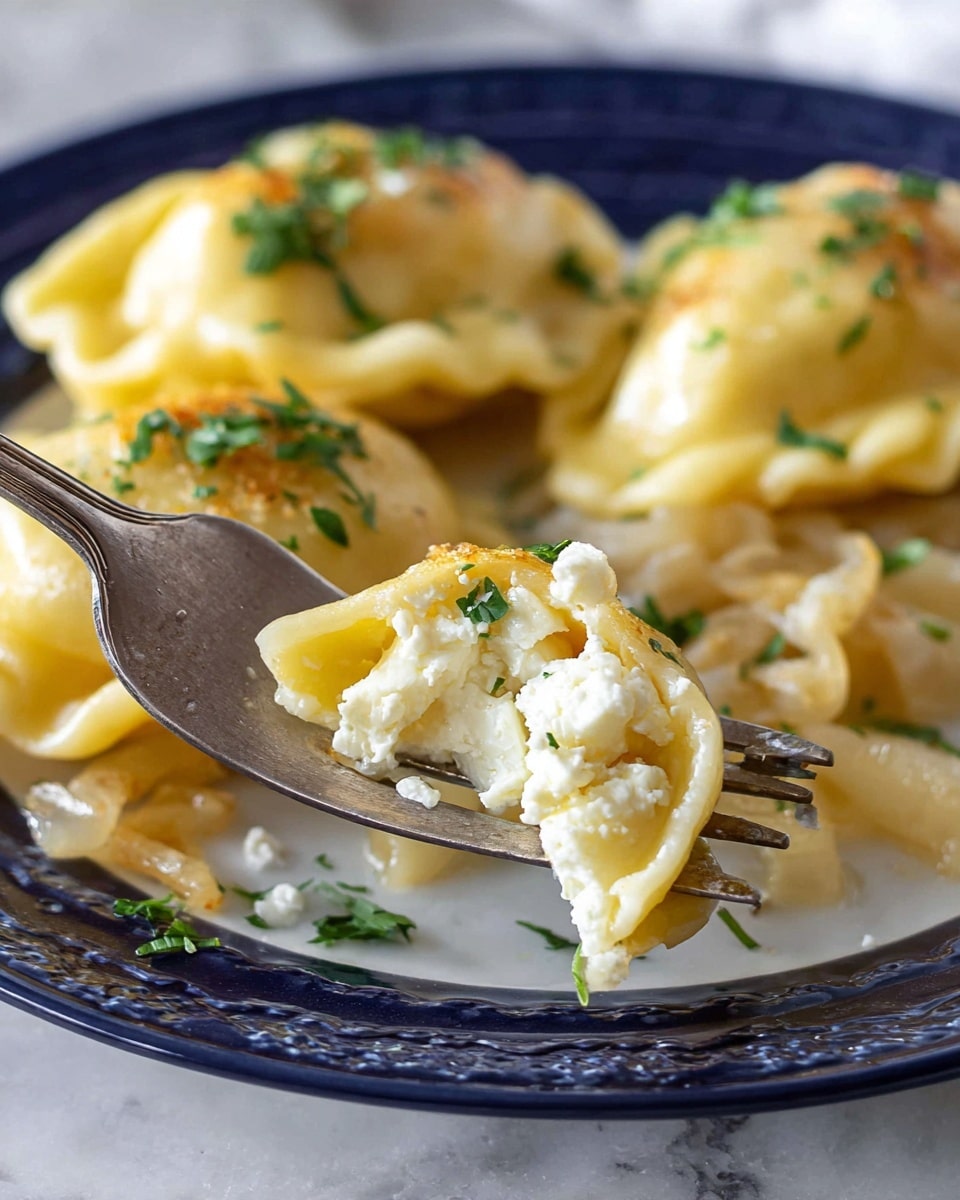 A close view of golden dumplings filled with soft white cheese, placed on a white plate, showing three dumplings with a soft texture and slightly wrinkled yellow outer dough on top of cooked, light brown onions sprinkled with chopped green herbs. A silver fork holds a piece of dumpling filled with crumbled white cheese in the foreground, all set on a white marbled surface. Photo taken with an iphone --ar 4:5 --v 7