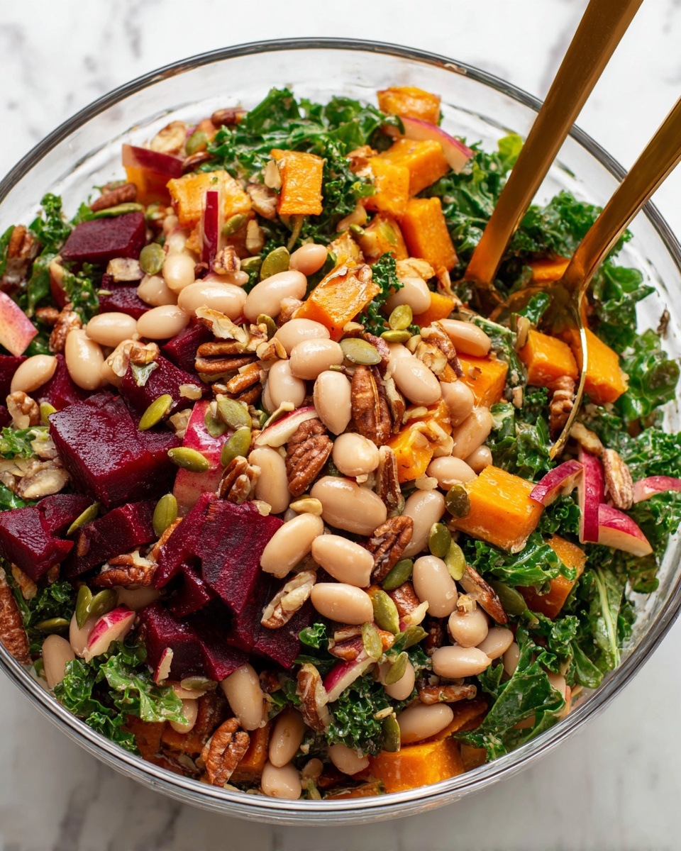 A clear glass bowl holds a colorful salad with many layers. The bottom layer is green curly kale leaves, mixed with white beans scattered throughout. On top of this are bright orange roasted squash cubes and small deep red beet strips, creating a vibrant look. Light brown pecan pieces and green pumpkin seeds add texture, mixed evenly across the salad. Pieces of red apple with pale flesh peek through, adding a fresh touch. Two bronze spoons stand in the salad, partially submerged among the ingredients. The bowl sits on a white marbled surface, showing a clean, bright background. Photo taken with an iphone --ar 4:5 --v 7